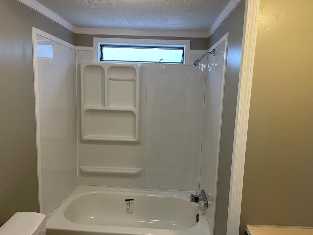 Bathroom remodel with updated tub surround, flooring, and fresh wall paint by JW'A Remodeling & Painting LLC